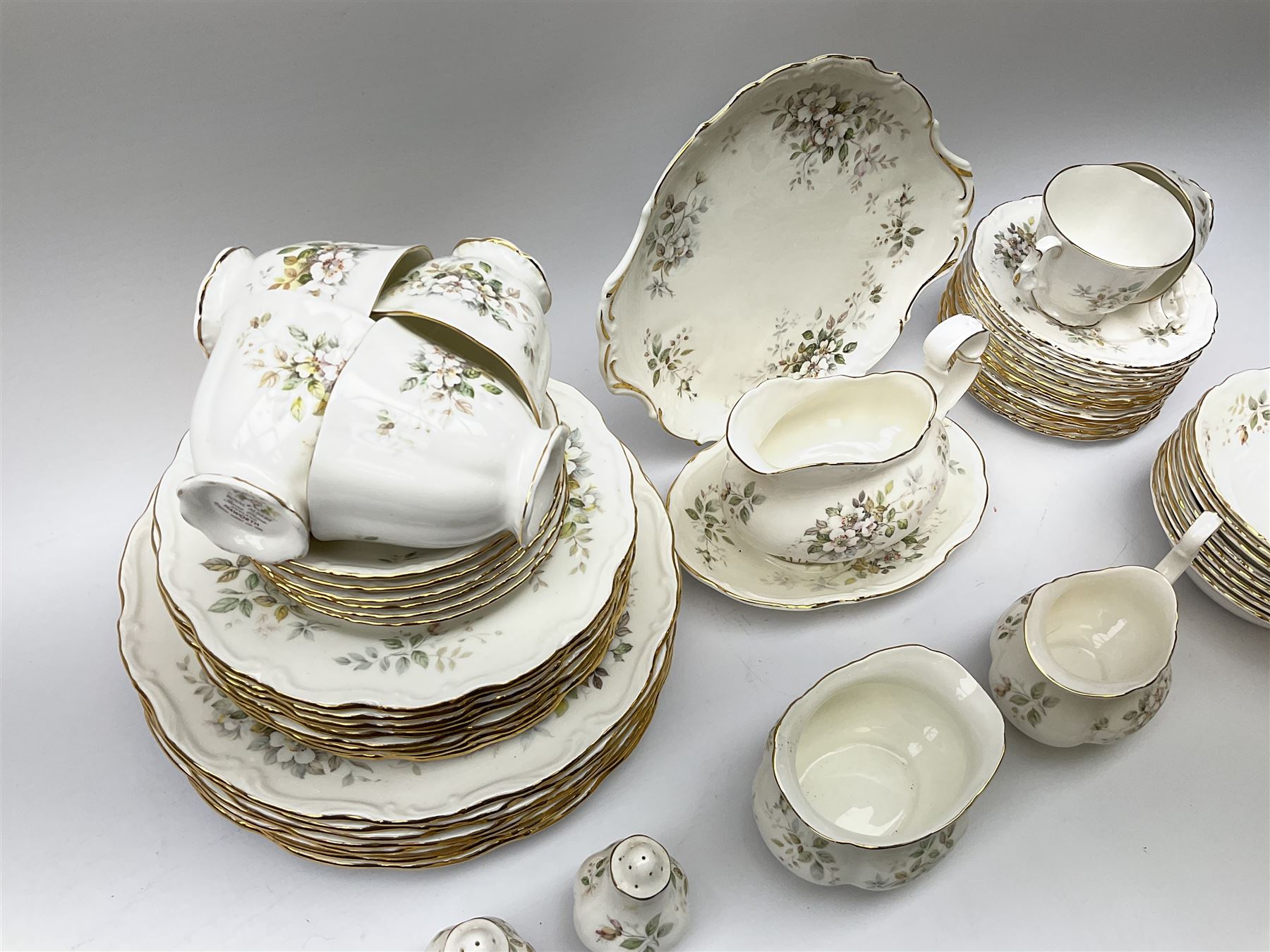 Royal Albert Haworth pattern tea and dinner wares, comprising eight dinner plates, ten salad plates, fourteen side plates, eight bowls, sauce boat and stand, pair of cruets, six tea cups and six saucers, cream jug, open sucrier, and cake plate. 