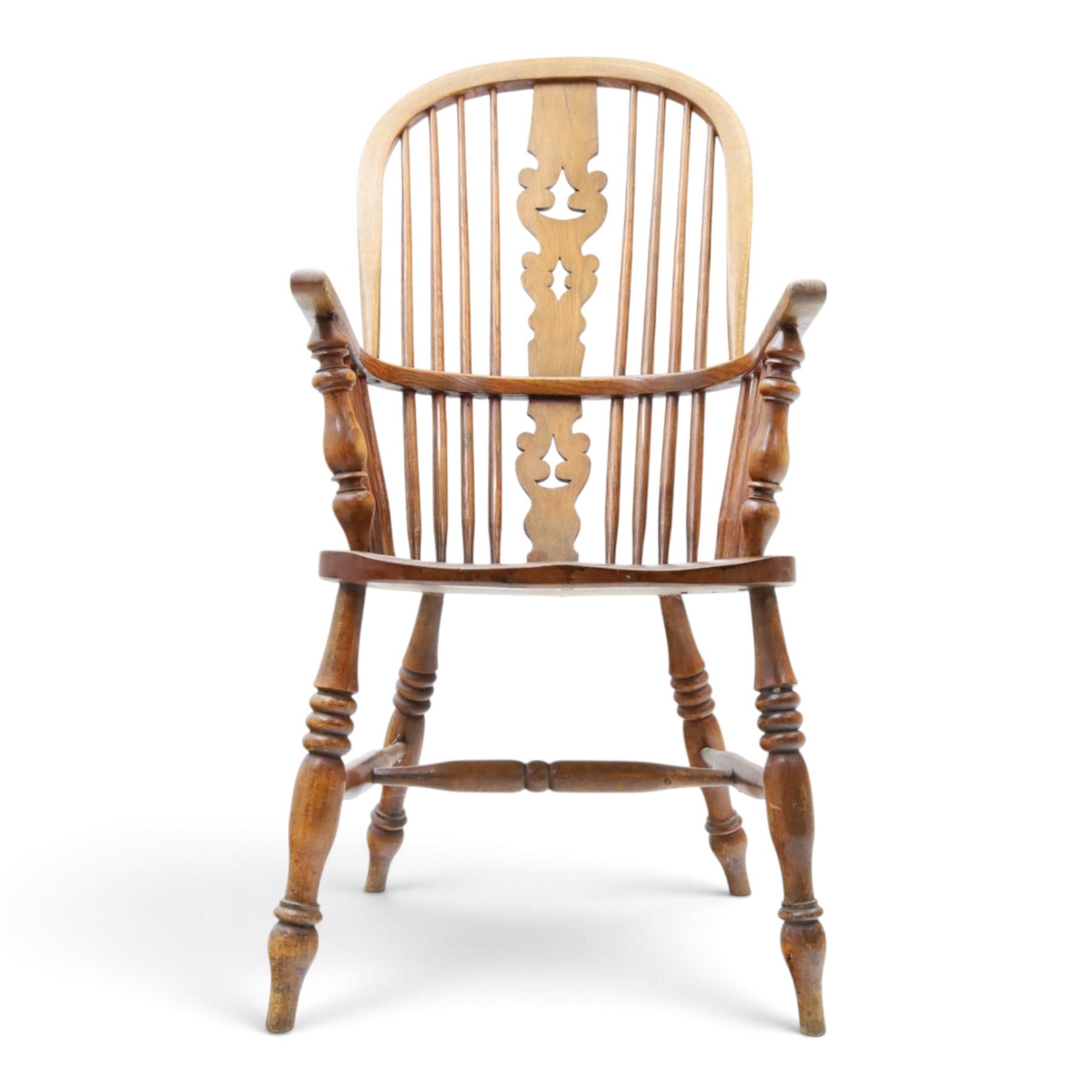 19th century elm Windsor armchair, with central pierced splat, flanked by spindles, dished seat, raised on turned supports united by H-stretcher