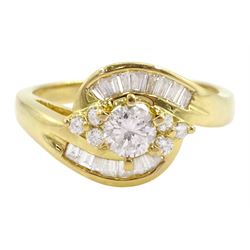 18ct gold diamond crossover ring, the central round brilliant cut diamond of approx 0.45 carat, with round brilliant and tapered baguette cut diamond surround, total diamond weight approx 1.00 carat