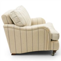 Pair of 20th century Howard shape armchairs, deep seat armchairs in cream and grep striped upholstery, raised on dark supports terminating in front castors