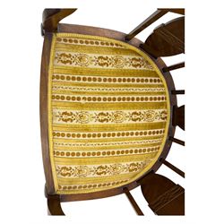 Late Victorian mahogany framed tub chair, rounded backrest with vertical splats and three carved oval medallions, upholstered seat in yellow patterned fabric, on cabriole supports