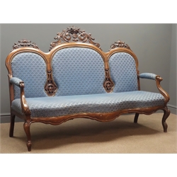  Victorian upholstered walnut sofa, triple arched cresting rail with ornate carved scrolling foliage pediments, shaped apron on cabriole legs, W172cm, D60cm, H120cm  