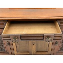 Late 19th century walnut sideboard, fitted with four drawers and four cupboards, carved detail