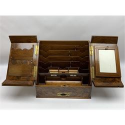 Late Victorian walnut correspondence box, the figured sloped front opening to reveal a fitted interior with letter rack, calendar, and pen tray between two inkwell recesses, above a pull out draw with recessed brass handle, H34cm L39cm D26cm