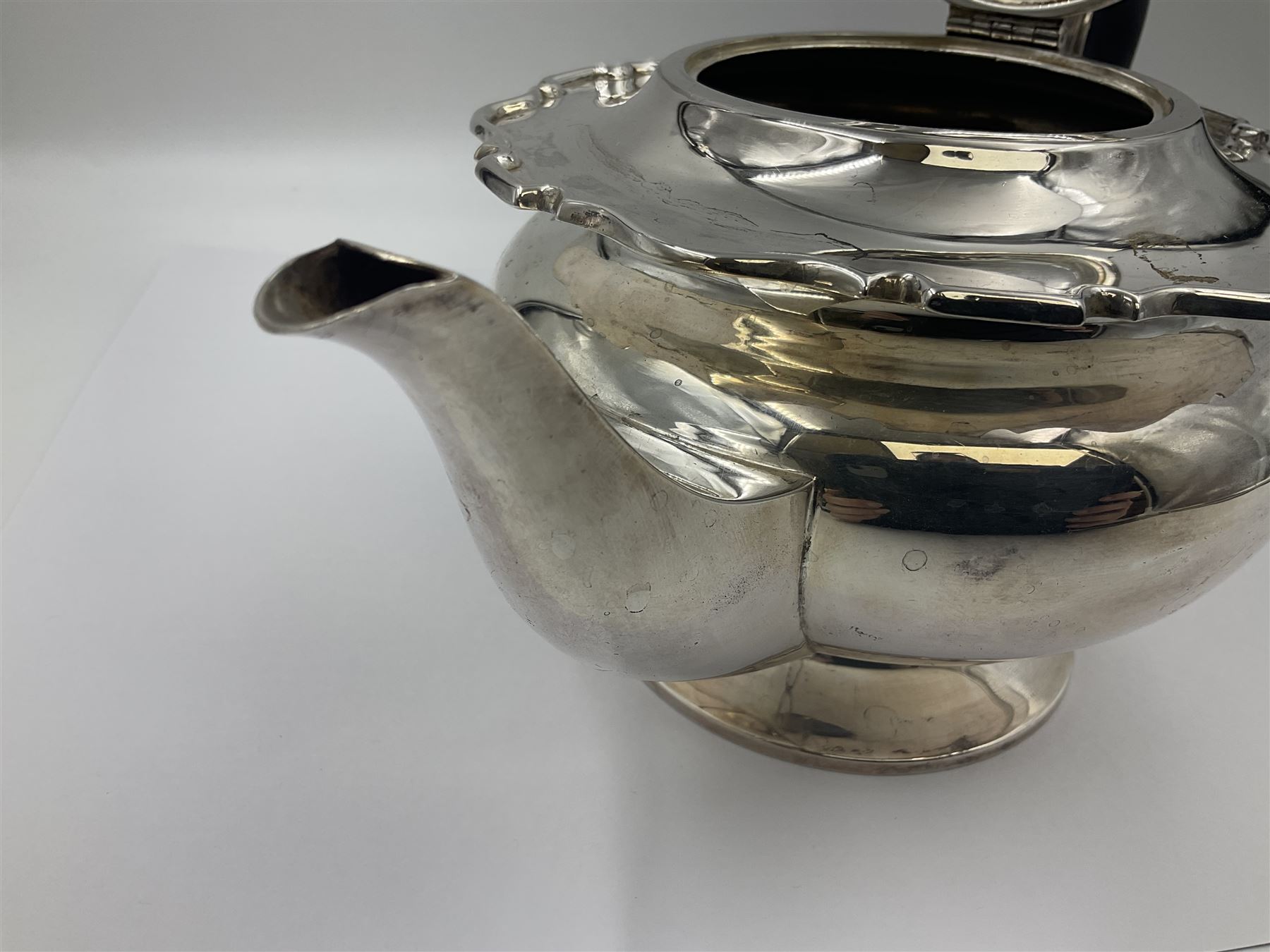 1920s five-piece silver tea service, comprising teapot, coffee pot, hot water pot, twin handled open sucrier and milk jug, each of squat circular form with shaped rim, the teapot, coffee pot and hot water pot each with ebonised handle and finial, the sucrier and milk jug with acanthus capped scroll handles, all upon circular foot, hallmarked R F Mosley & Co, Sheffield 1926 & 1927, tallest H24cm