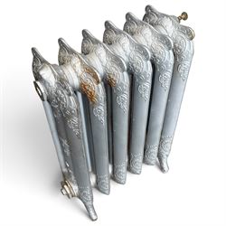 French ornate cast iron column radiator of Rococo Revival design, each section cast with scrolling foliate decoration with rocaille and cartouche motifs, with brass valve and integral bracket feet, in painted silvered finish