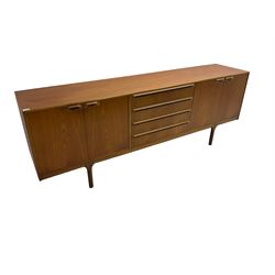 Tom Robertson for AH McIntosh & Co of Kirkaldy - mid-20th century teak sideboard, fitted with four central drawers, flanked by cupboard enclosing shelves and sliding tray, raised on cylindrical supports