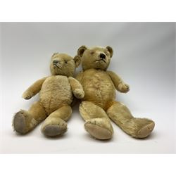Two large graduated Chiltern teddy bears 1930s-50s each with swivel jointed head, glass eyes and vertically stitched nose and mouth and jointed limbs, largest H27.5
