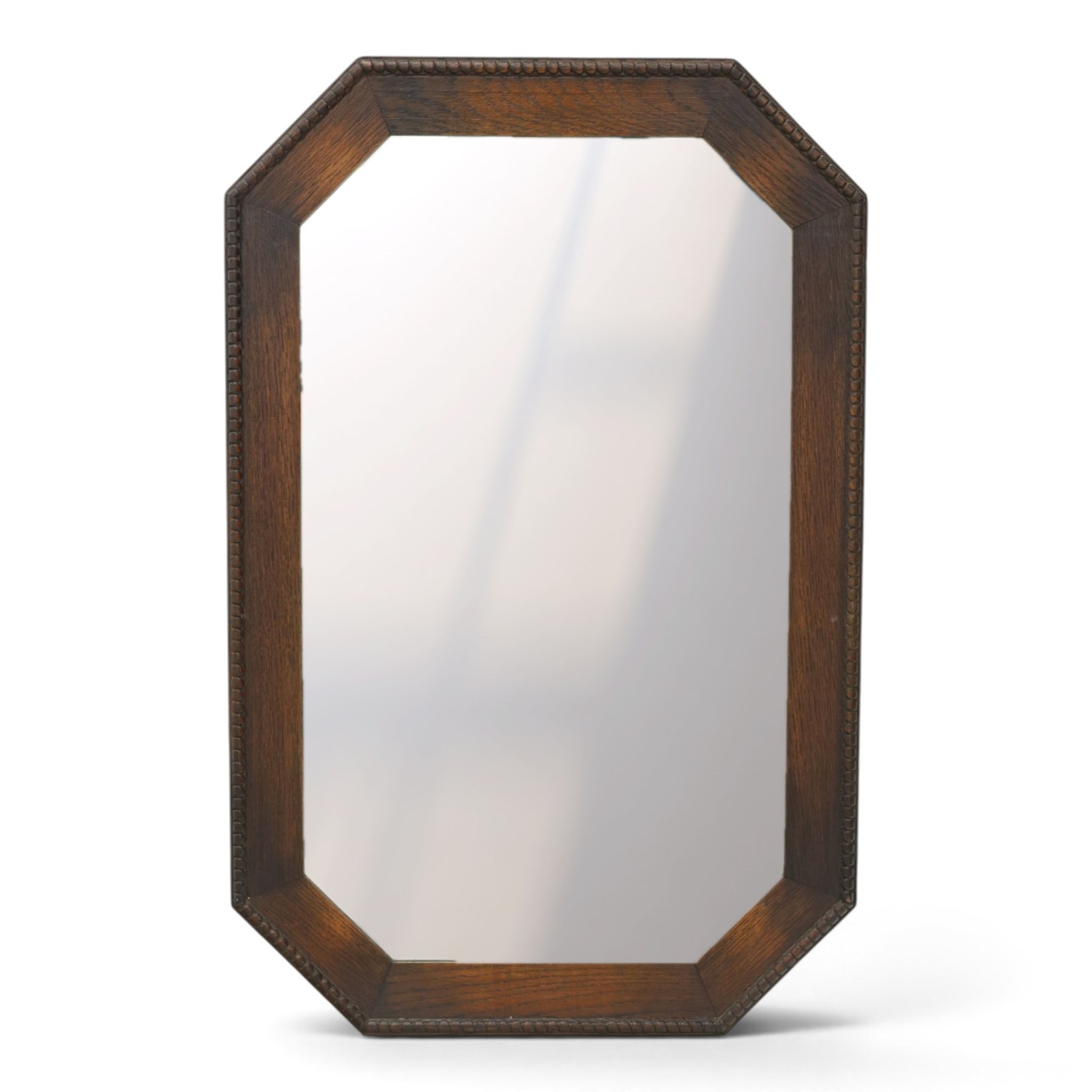 Early 20th century oak wall mirror, canted rectangular frame with bevelled plate 