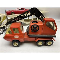 American Nylint large scale tin-plate car transporter L59cm carrying a Testor Toys plastic car; Tonka tin-plate mobile crane; boxed Sarony Cigarettes tin-plate roulette game with rules; and Japanese style tin-plate box, the lid inset with a revolving poker dice game (4)