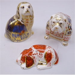  Three Royal Crown Derby Dog paperweights: Bulldog dated 1990, Kind Charles Spaniel dated 1993 and Sleeping Puppy designed exclusively for the Royal Crown Derby Collectors Guild dated 2000, gold stoppers (3)  
