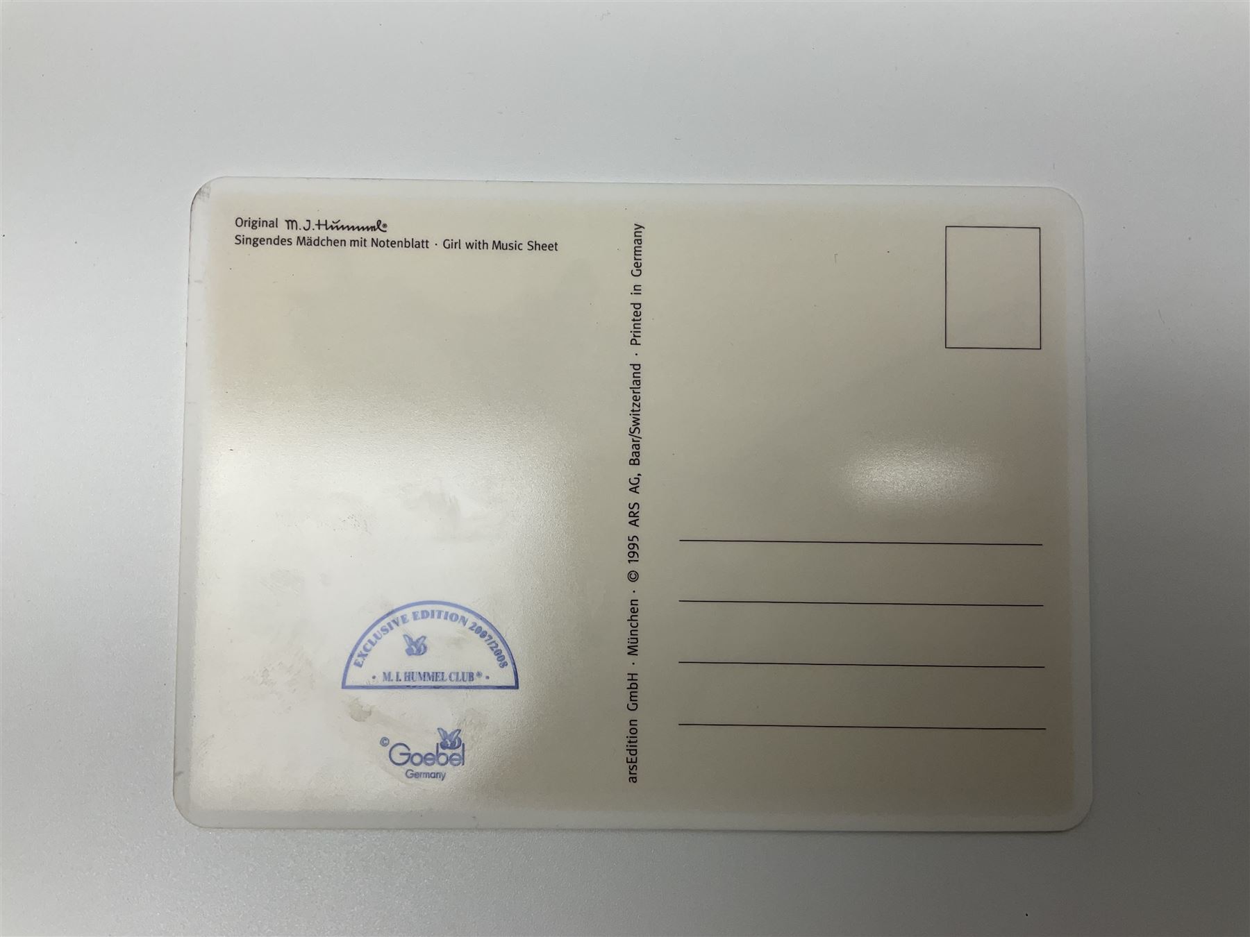 Two ceramic Hummel postcards by Goebel, both displayed on wooden easels, together nine Hummel eggs, set of four Hummel School Days plates, on wooden hanging rack, Goebel Collectors Club Member plaque etc