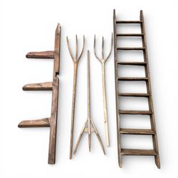 Three wooden pitch forks along with wooden saddle rack and wooden steps