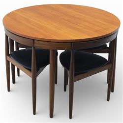 Frem Røjle - Danish teak 'Roundette' extendable dining table, circular top with softly chamfered edge and internal stowable leaf extends to 156cm, raised on four tapered cylindrical legs, accompanied by four matching dining chairs with shaped teak frames and black vinyl upholstered seats, the chairs designed to nest beneath the table when not in use