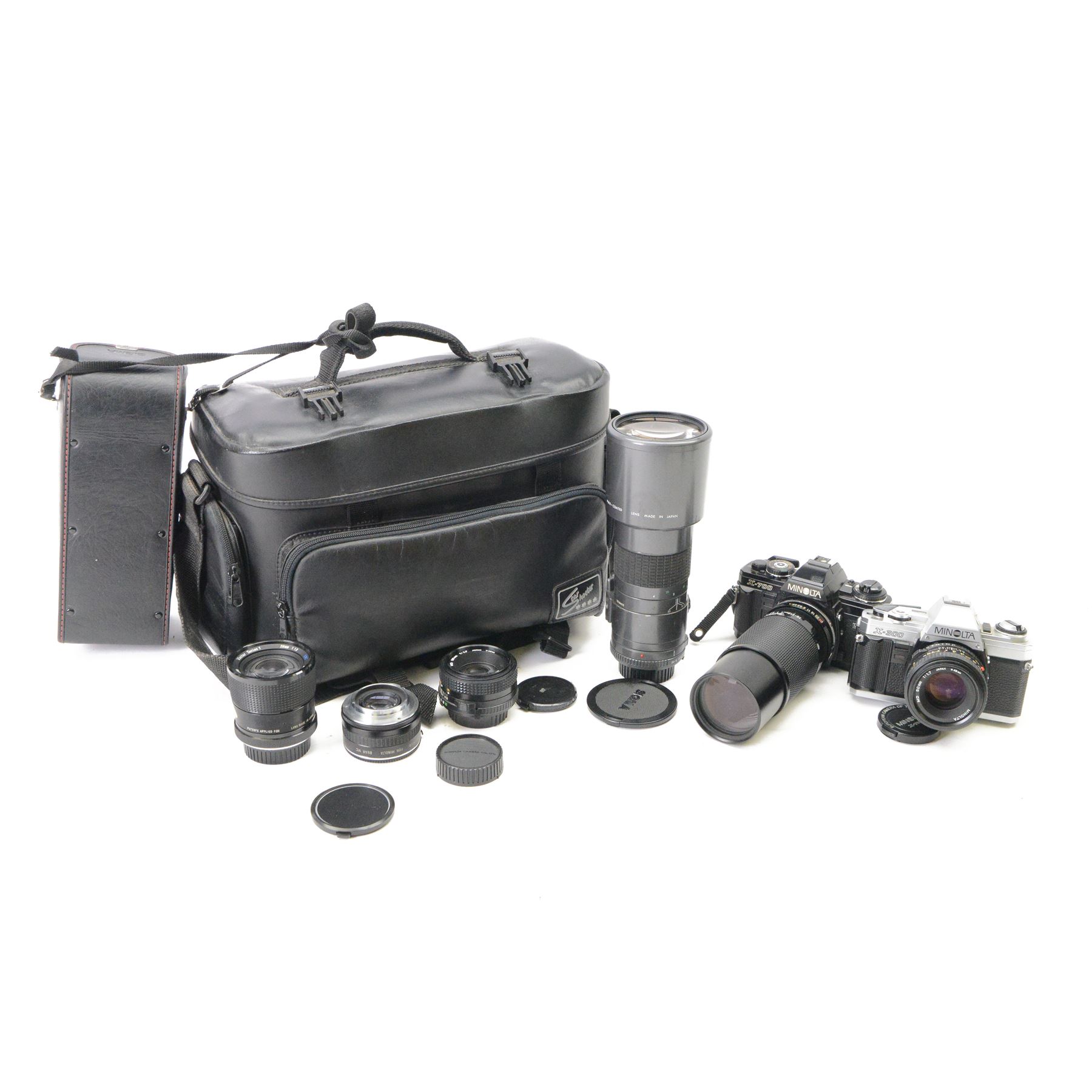 Two Minolta SLR camera bodies, comprising X-300 serial no. 8592491 and X-700 serial no. 1498583, together with five lenses including Sigma Telephoto 1:5.6 f=400mm serial no. 1018435, Vivitar Series 1 28mm 1:1.9 VMC Auto Wide Angle Lens no. 37822044, two Minolta MD 50mm 1:1.7 49mm lens nos. 7177581 & 8384472, Tamron 70-210mm 1:3.8-4 lens no. 8316867 and camera accessories, all within a soft carry case