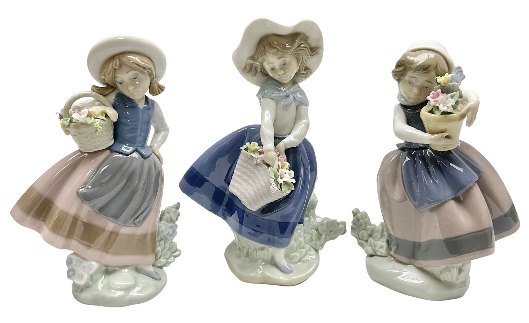 Three Lladro Flower Girls figures, comprising Sweet Scent no 5221, Pretty Pickings no 5222 and Spring is Here no 5223, largest example H18cm 