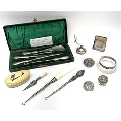 Cased silver handled glove stretcher, button hook, shoe horn, etc., hallmarked Adie & Lovekin Ltd, Chester 1911, and Adie & Lovekin Ltd, Birmingham 1911, miniature silver mounted hymn book, the cover embossed with cherubs, silver handled button hook, ivory handled button hook with silver ferrule, two silver dressing table pot lids, etc. 