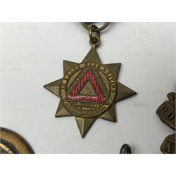 Made-up group of three WWI medals comprising 1914 Star awarded to 23598 Gnr. F. Jefferson R.G.A., British War Medal and Victory Medal with names removed; with ribbons on wearing bar; 1942 Motorist's Medal and small quantity of cap badges, Royalty badges etc