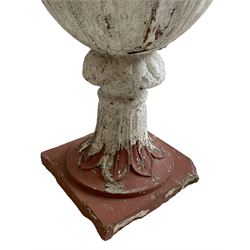 Early 20th century terracotta garden urn, the body and rim in the form of rising and splayed leaves, on moulded footed base with further leaf decoration