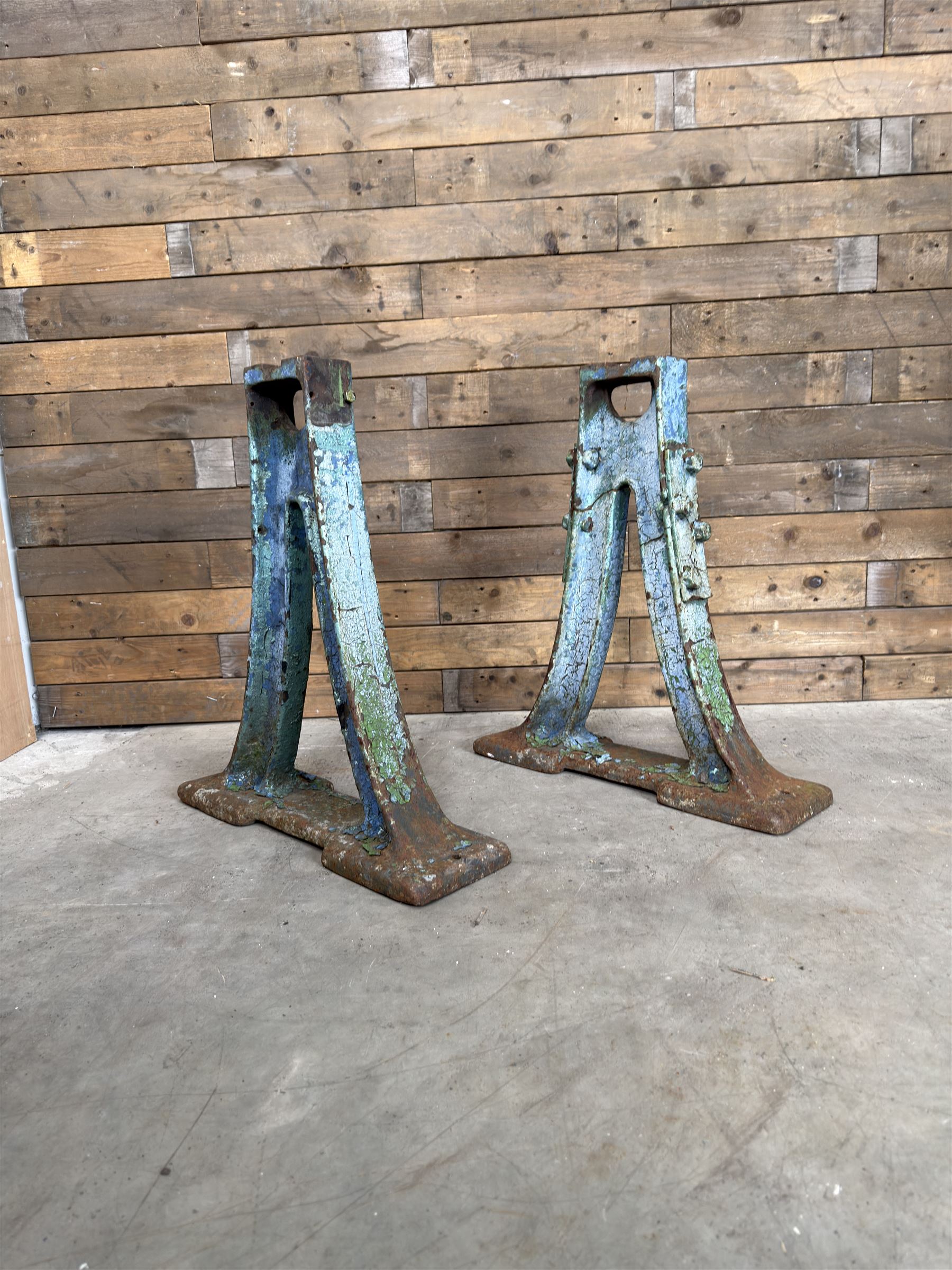 Pair of late 19th century heavy cast iron garden industrial trestles, painted in distressed blue paint