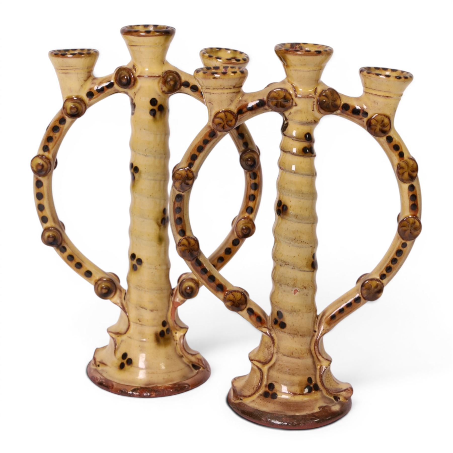 Pair of studio pottery candlesticks, with a central twisted column bordered by circular supports, H24cm 