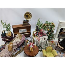 Dolls house furniture, including pianos, fireplace, plants, flower arrangements, tables, chairs, six figures and a collection of instruments and other accessories