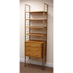  Staples Laddarax teak wall unit, gold painted metal frame, chest with three drawers, four shelves, W64cm, H202cm, D41cm  