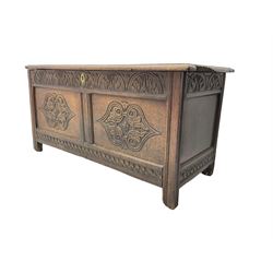 18th century oak blanket chest or coffer, rectangular hinged top with three panels and moulded edge, frieze carved with lunette and acanthus leaf decoration, two front panels carved with scrolling motif, raised on stile supports