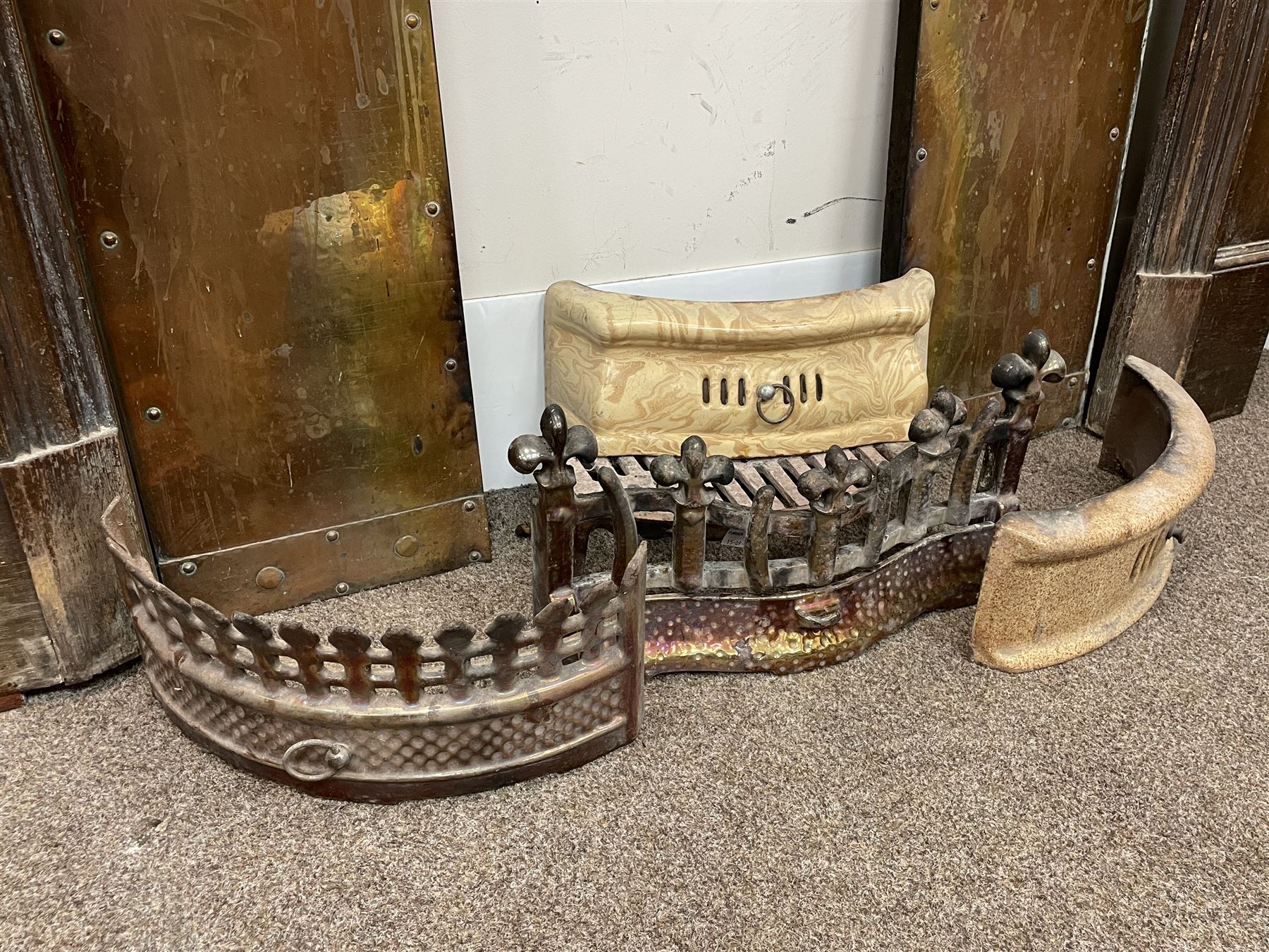 Late 19th/early 20th century fireplace, oak surround with projecting dentil cornice over bevelled mirror and shelf, with copper inset decorated with Heraldic knot motifs and rivets, together with various fire accessories 