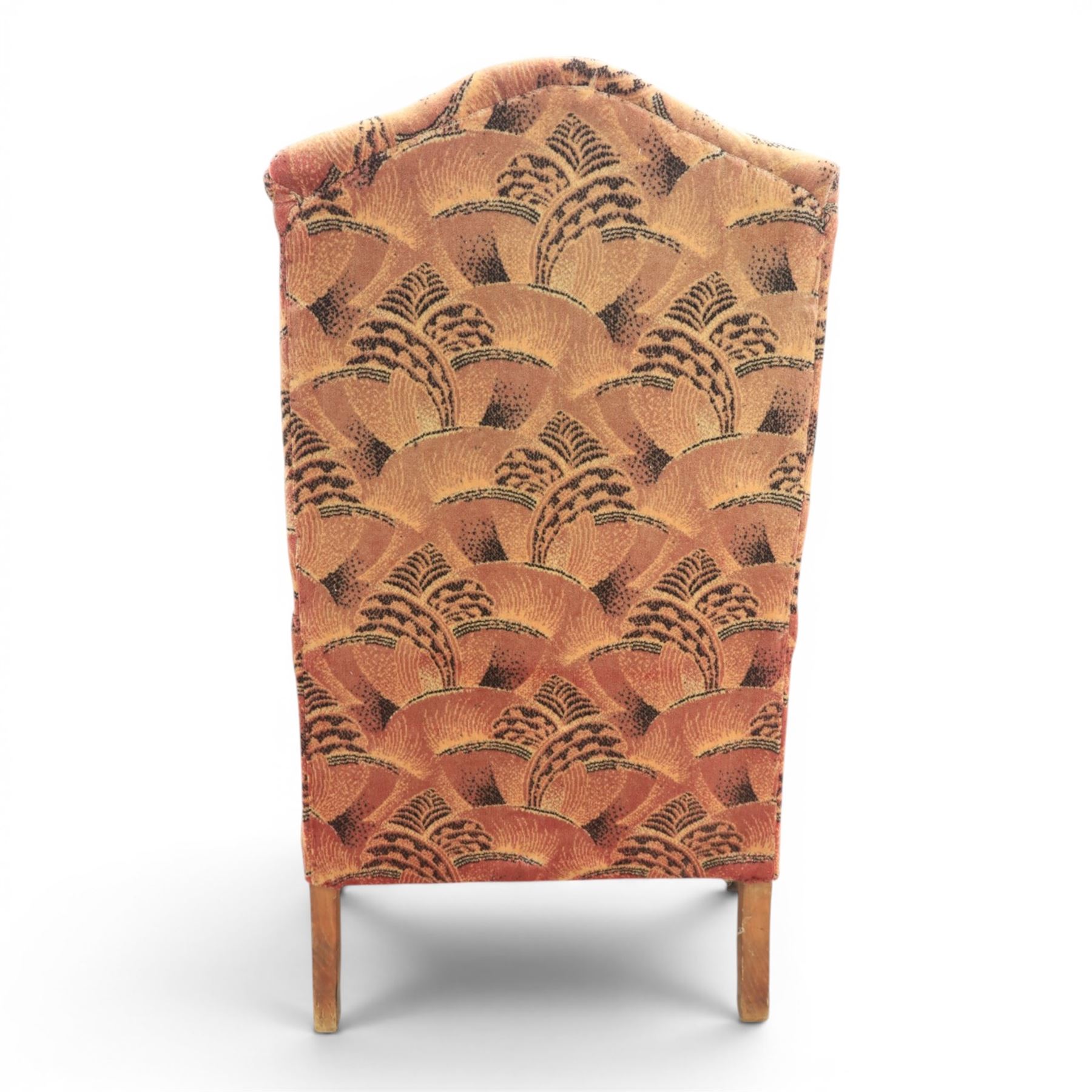 Large upholstered wingback chair, crimson geometric upholstery, carved front apron raised on cabriole supports 