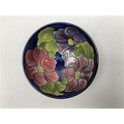 Moorcroft Clematis pattern footed bowl on a blue ground, with with impressed and painted mark beneath, D15.5cm