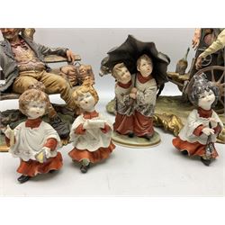 Group of Capodimonte figures, to include musical organ grinder with donkey and monkey example, tramp figure on bench, and choir boy and girl figures