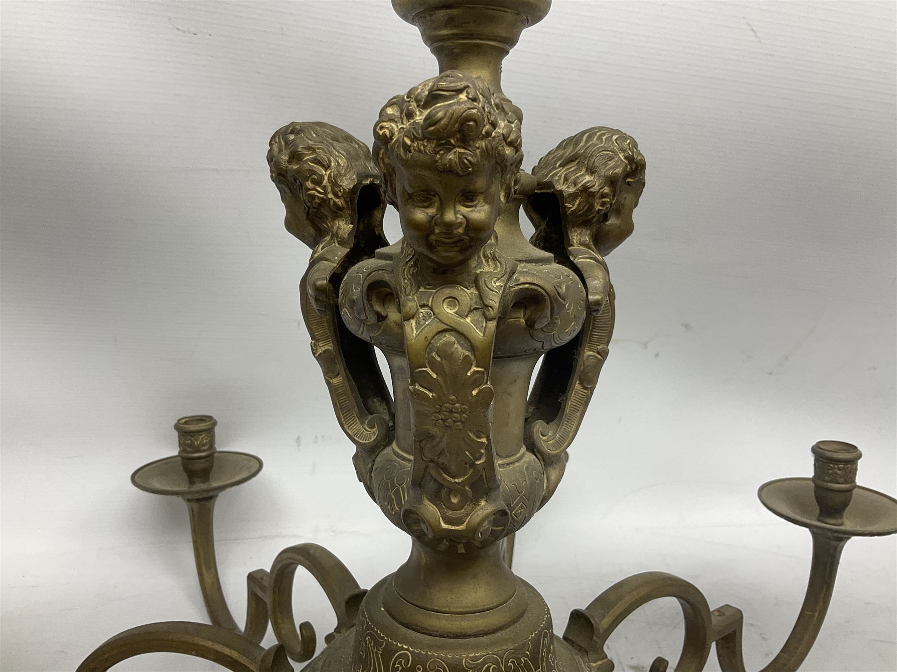 20th century heavy brass eight branch electrolier, detailed with putti masks, approximately H60cm W71cm