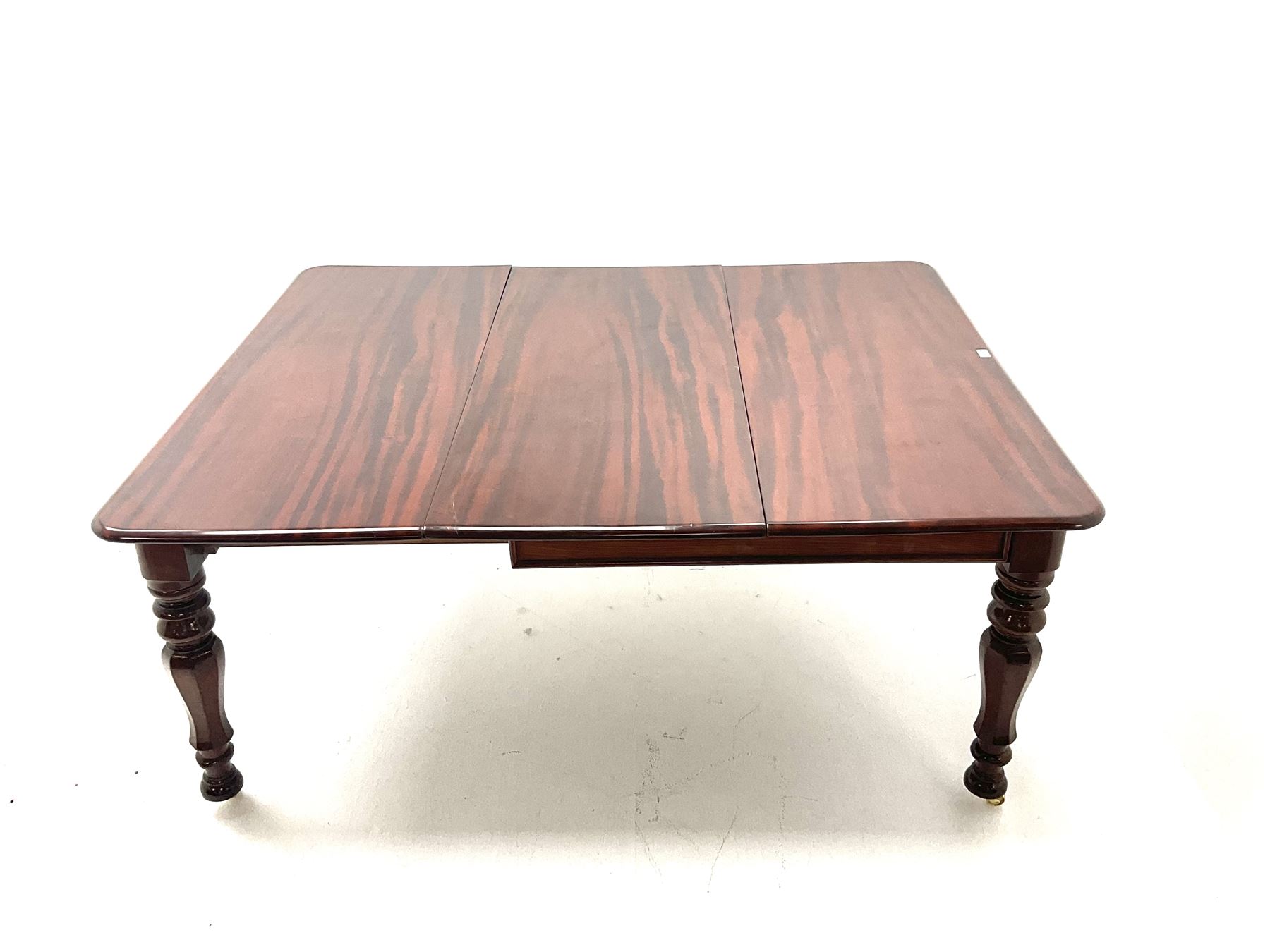 Victorian mahogany extending dining table with three leaves, turned and