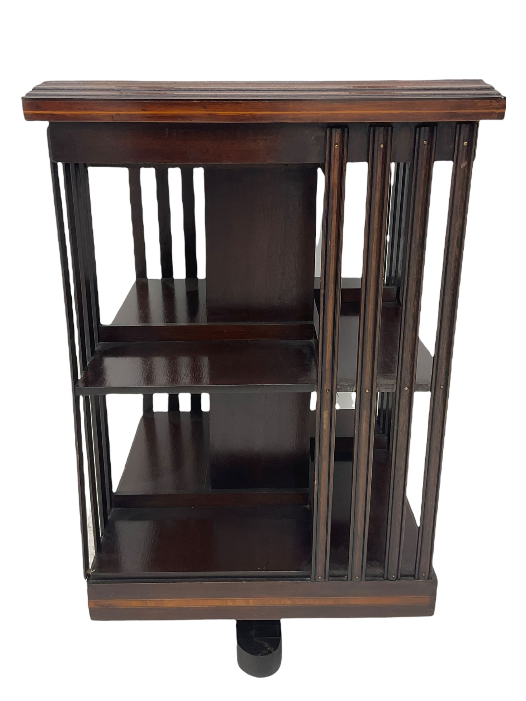 20th century mahogany revolving bookcase, inlaid centre motif, satinwood banded border