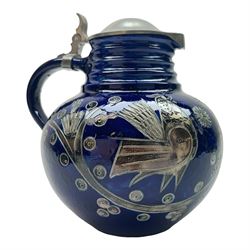 Wim Muhlendyck (1905-1986),  saltglaze stoneware jug of globular form with pulled and applied handle and ribbed neck with white cover, with stylised cockerels and flowers on a dark blue ground, with makers mark beneath, H22cm