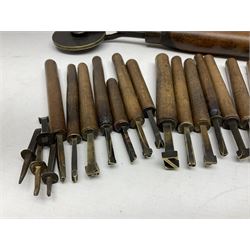 Thirty-one bookbinder's brass number and letter stamps, predominantly with beech handles, together with a bookbinder' decorative fillet roll, with brass triple line wheel stamped E. Menuel London, with wood handle, and two ink blotters