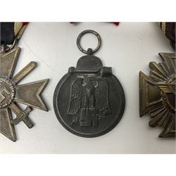 WW2 German Eastern Front Medal awarded to those who served on the German Eastern/Russian Front during the Winter Campaign period of 15th November 1941 to 15th April 1942 with original ribbon; German War Merit Cross with swords; and NSDAP Long Service Award (3)