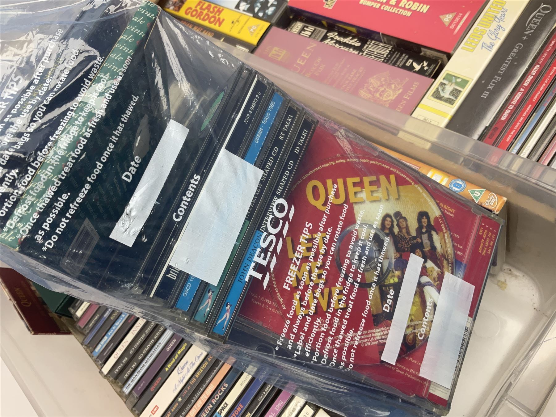 Large collection of VHS tapes, DVDS, CDs to include Queen, James Bond 007, Batman etc, in three boxes