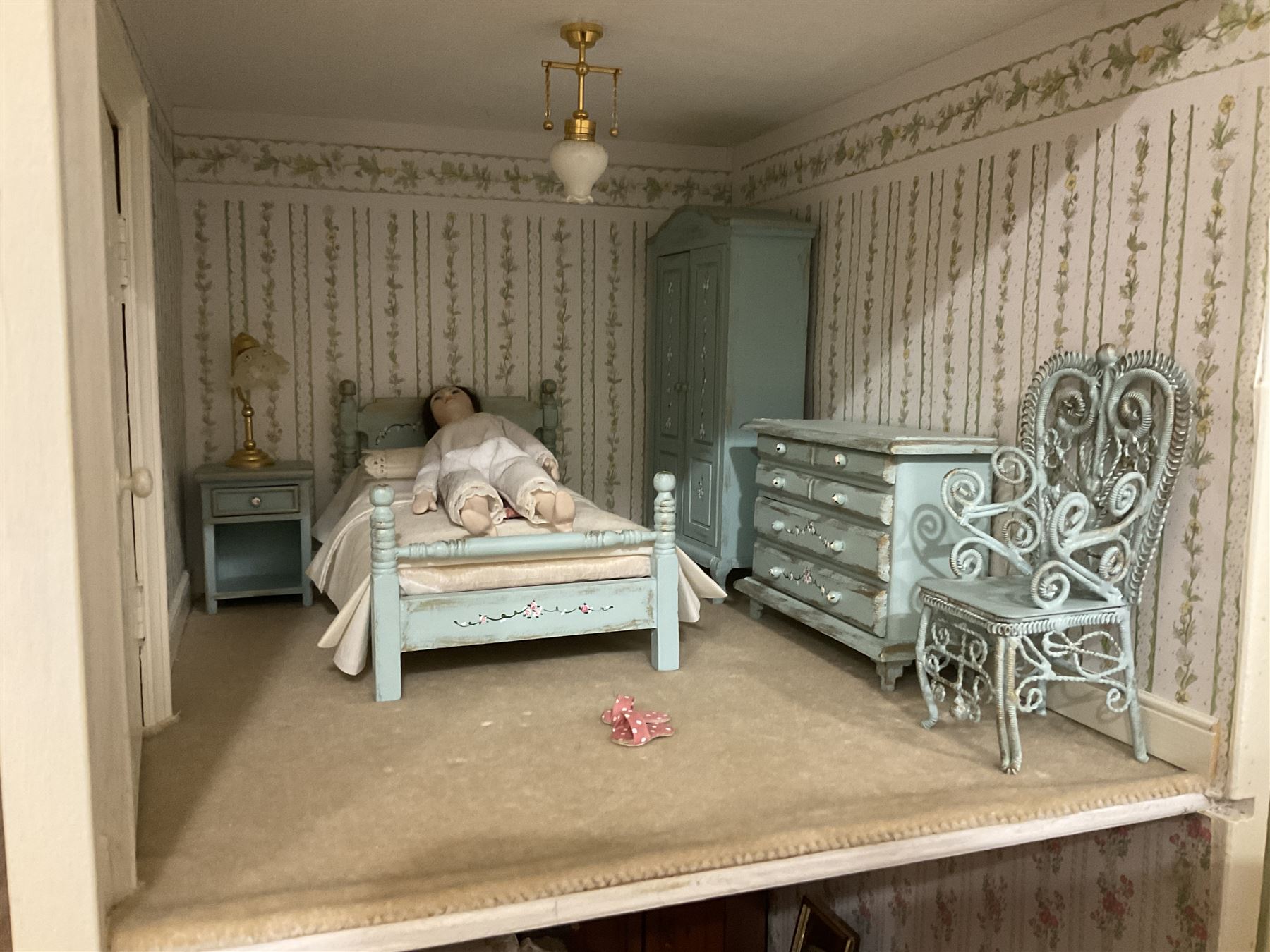 Honeychurch kit-built large wooden dolls house as a 19th century style double fronted four storey town house; with stucco finish under a pitched roof with Palladian style pediment and simulated tiles; protruding front courtyard with railings, street light and steps giving access to two fully furnished basement rooms; central door with Ionic columns and entablature; double hinged front facade opening to reveal a fully furnished interior with hall, stairs and landings and two rooms on each floor; wired for electric wiring W67cm H102cm D58cm