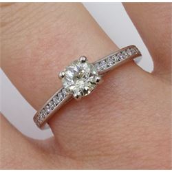 Platinum single stone diamond ring, with channel set diamond shoulders, hallmarked, central diamond approx 0.50 carat