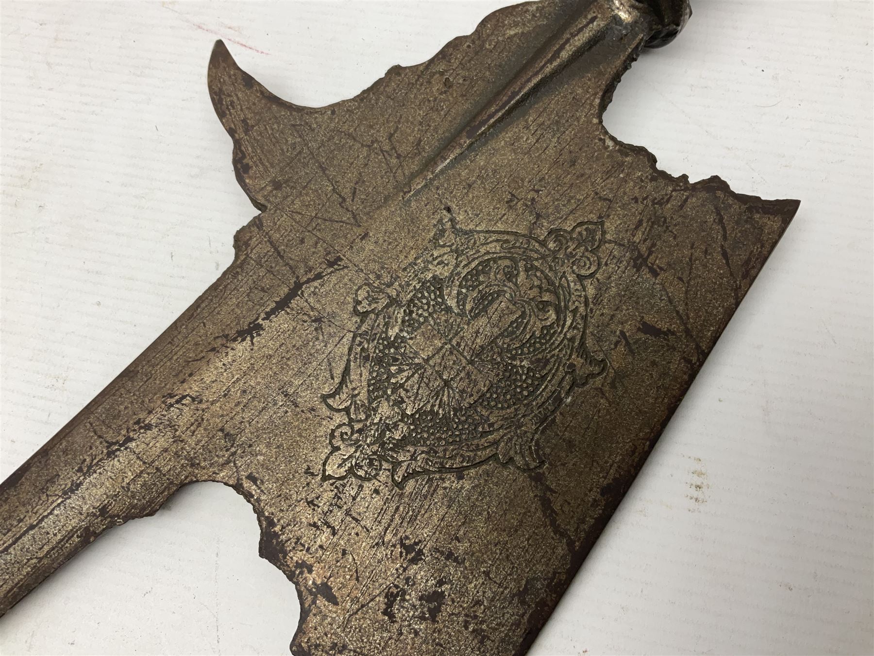 Moroccan jambiya dagger with 24.5cm plain curved blade stamped LONDON to the ricasso area, the hilt and scabbard overlaid with plain sheet brass to the back and ornate silver coloured metal to the front; waisted grip and arched pommel; two pyramid mounts to the scabbard L41cm overall; large billhook with curving blade and stacked leather washer grip; and a reproduction halberd blade (3)