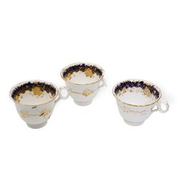 19th century porcelain part tea service, probably Spode, comprising sucrier, milk jug, sandwich plate, seven cups and two saucers, decorated with floral sprays, within cobalt blue and gilt borders, pattern no. 735 