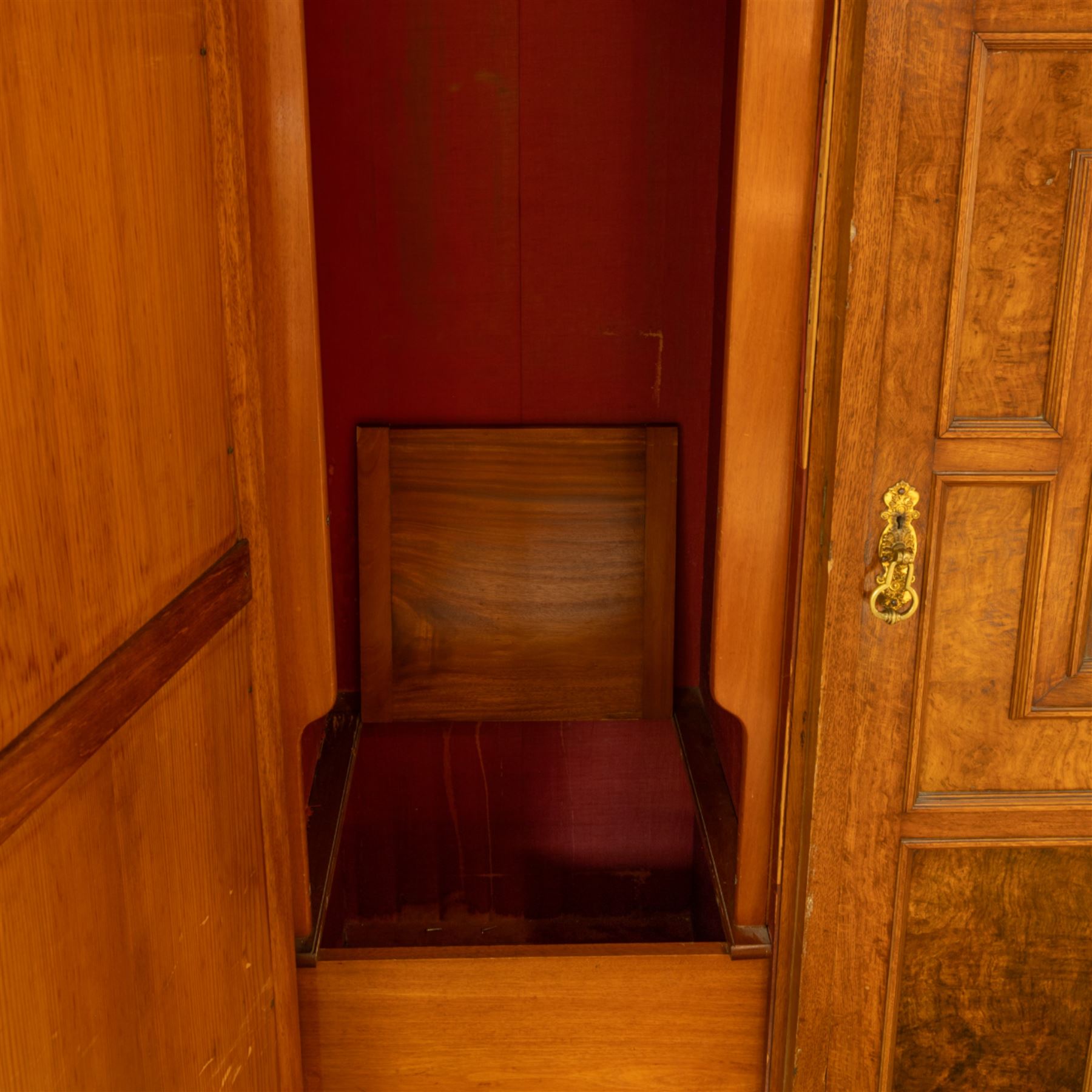 Late Victorian oak and burr oak three-section mirror wardrobe, central door with three carved panels with shell and acanthus decoration, fitted with four drawers and four tray drawers, linen sides with bevelled mirrored panel doors with hanging space, plinth base, and dental cornice