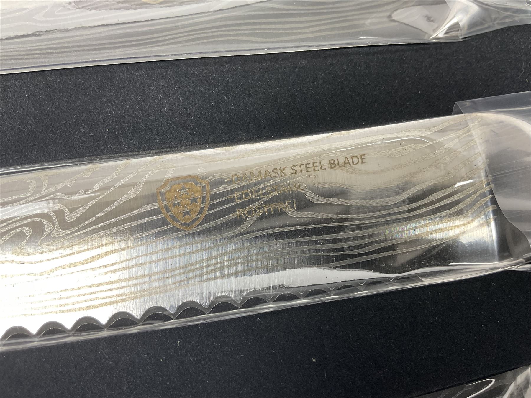 Two cased Swiss knife sets