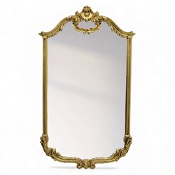 Late 20th century giltwood pier glass in a Rococo style, with rectangular mirror plate bordered by a heavily scrolled frame and foliate cresting