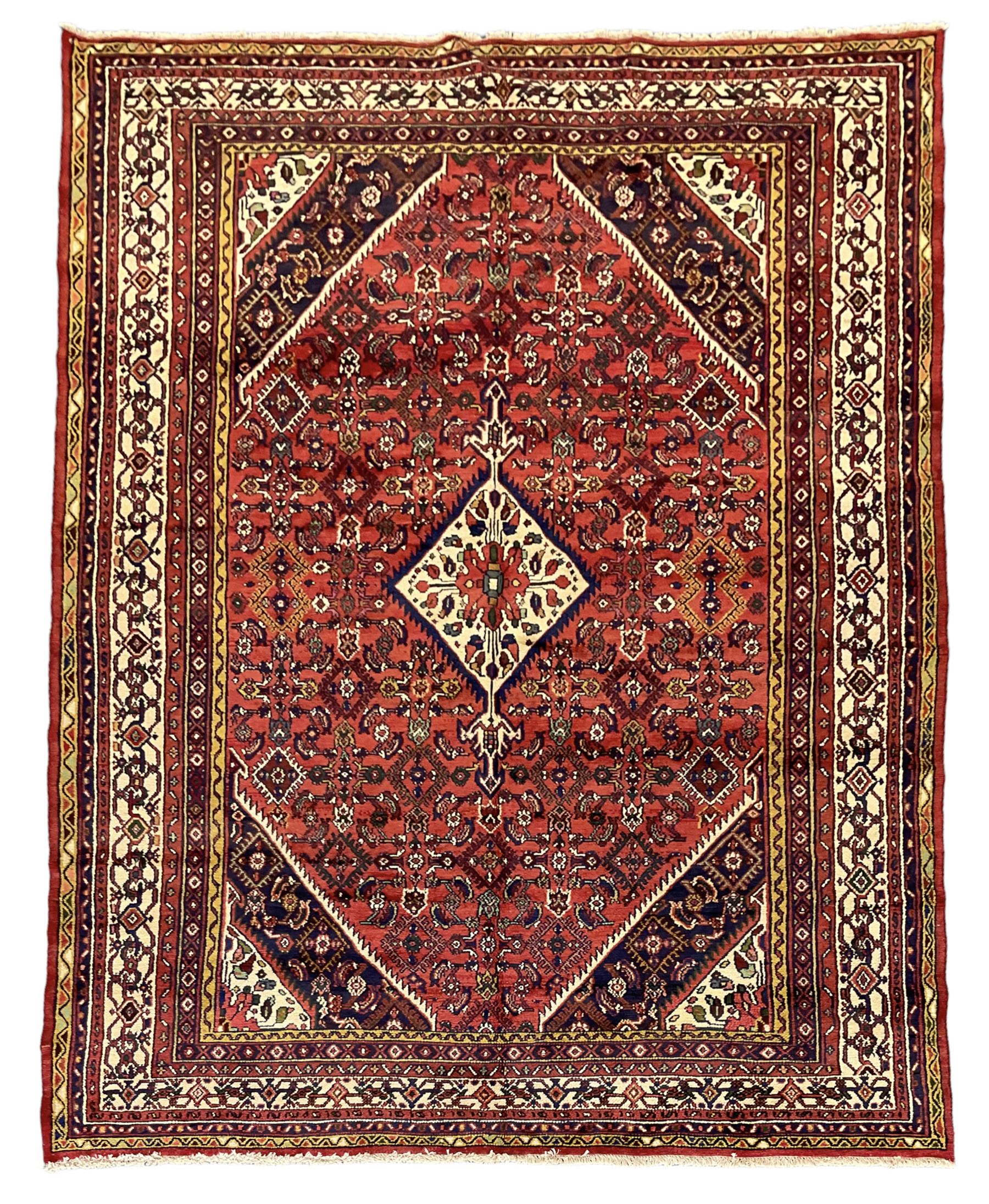 North West Persian Hamadan carpet, the extended lozenge field decorated with Herati motifs, central lozenge medallion, multiple border bands decorated with geometric designs 
