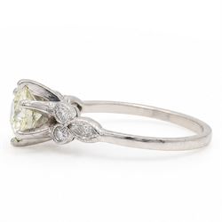 Platinum diamond ring, six claw set with a single old cut diamond of approx 1.35 carat, each shoulder milgrain set with two single cut diamonds and a marquise cut diamond, stamped Plat