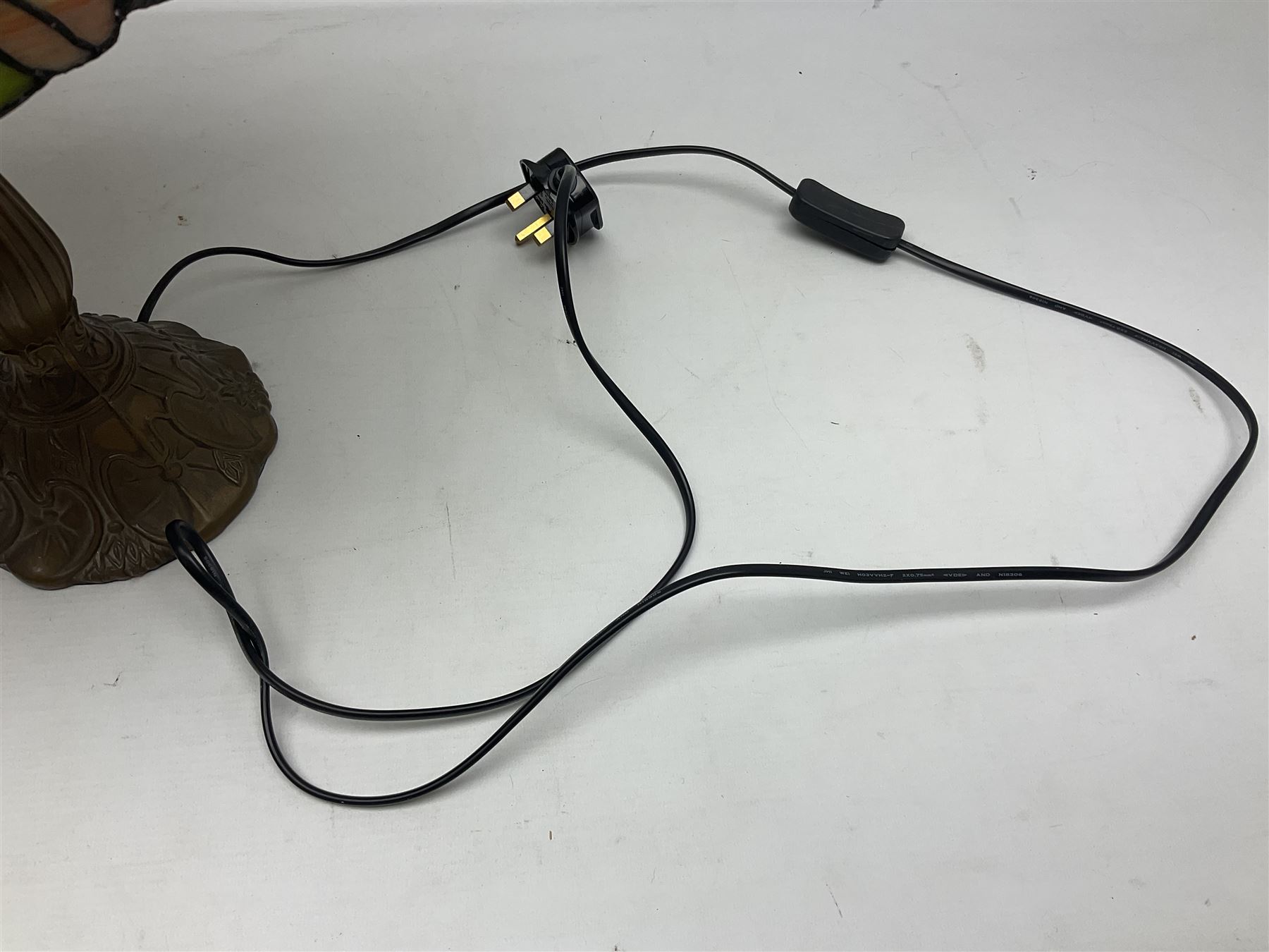 Tiffany style lamp in the form of a semi nude woman holding up a leaded lampshade together with a similar table lamp