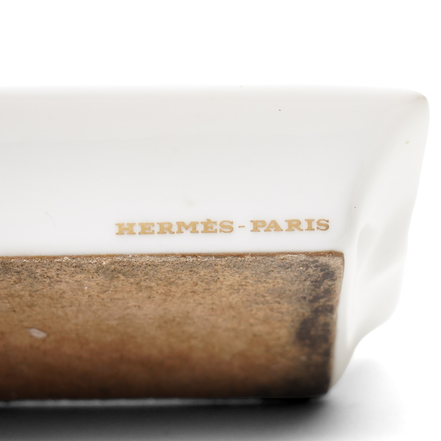 Hermès - set of four miniature porcelain ashtrays, each decorated with a horse in differing blanket, with gilt and coloured borders, in contrasting colour with various horse-coats, in original fitted box
